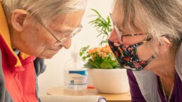 A relative sitting with their loved one with dementia in our care home